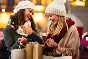 Two happy women Christmas shopping